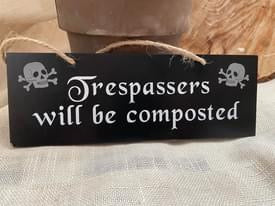 Trespassers will be composted hanging sign